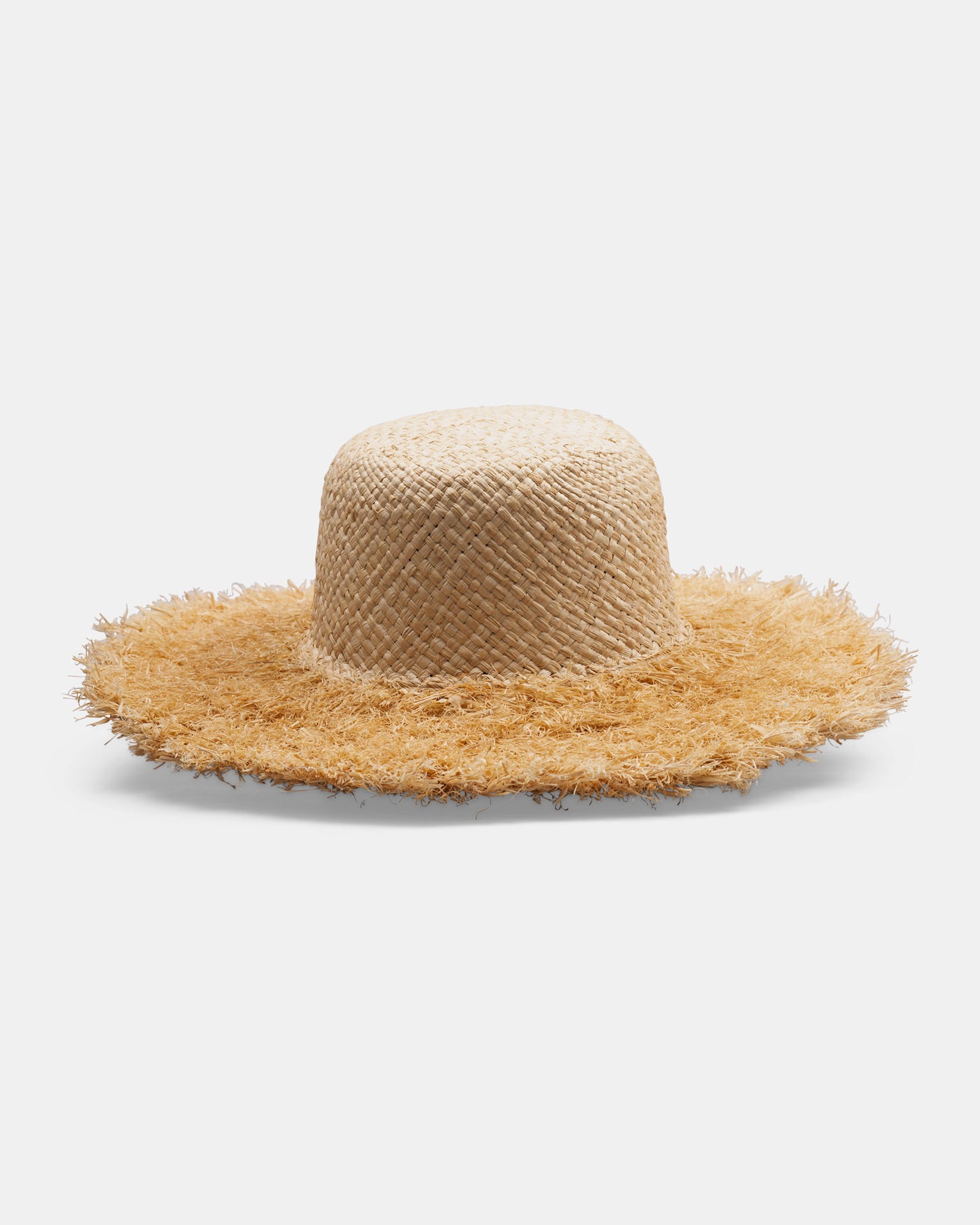 Wide brim straw hat with frayed edges, handmade, natural woven texture, on white background