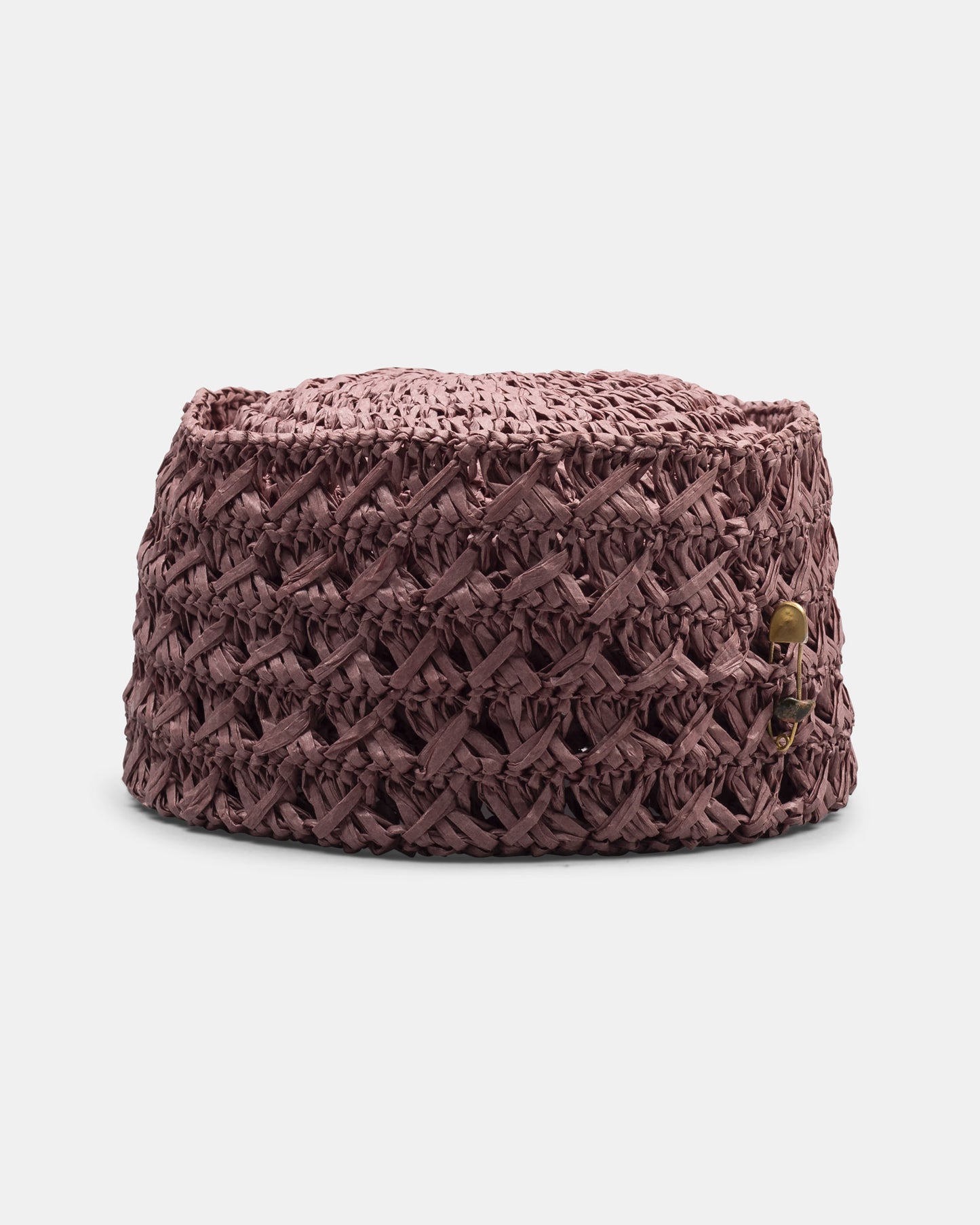 Handwoven purple straw hat with textured criss-cross pattern, side brass accent, on white background