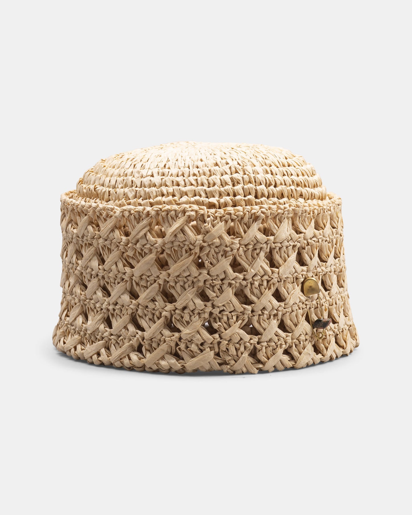 Handmade Italian straw bucket hat with textured weave and gold accent on white background.