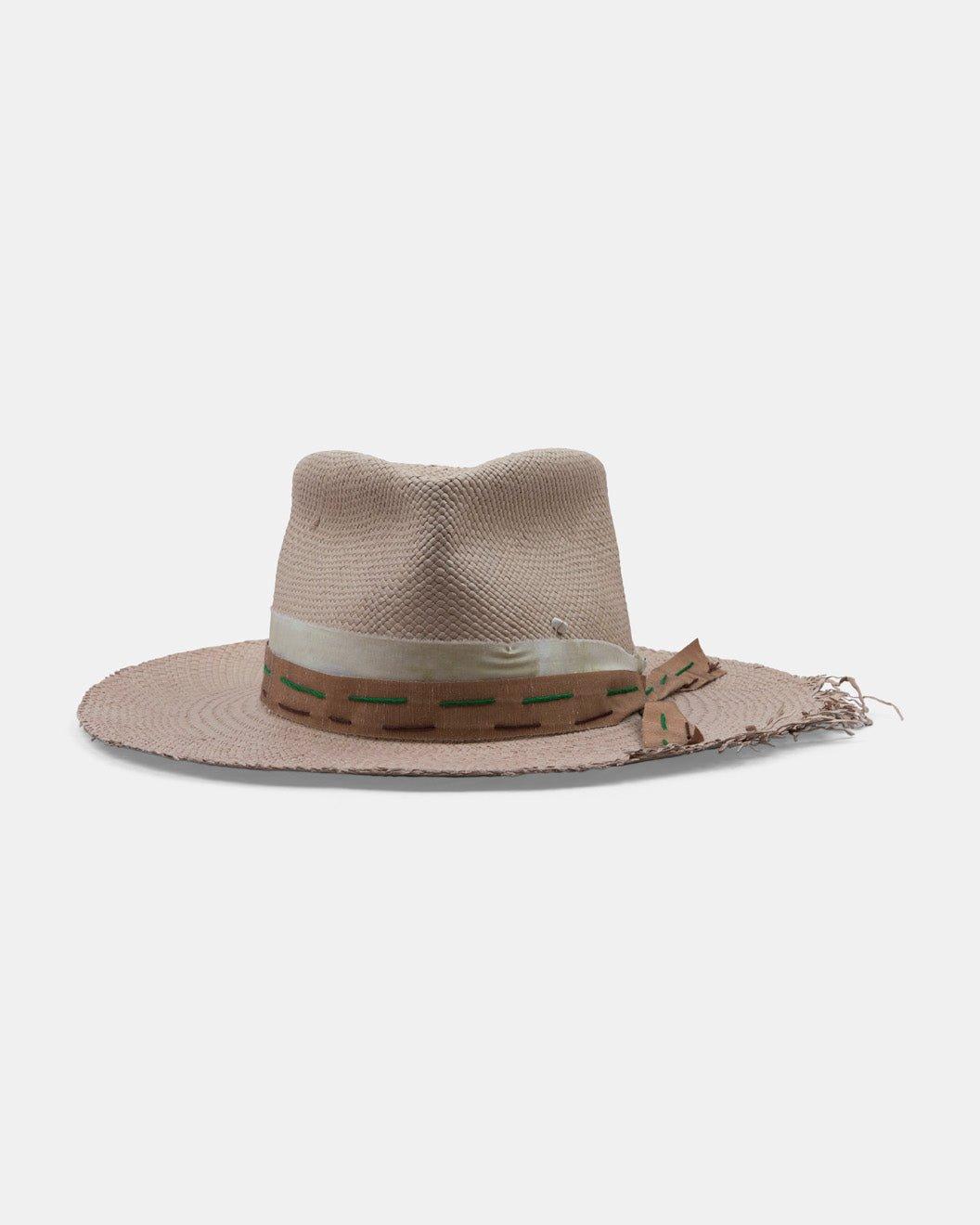 Beige Panama hat with wide brim, decorative ribbon and frayed edge on a white background