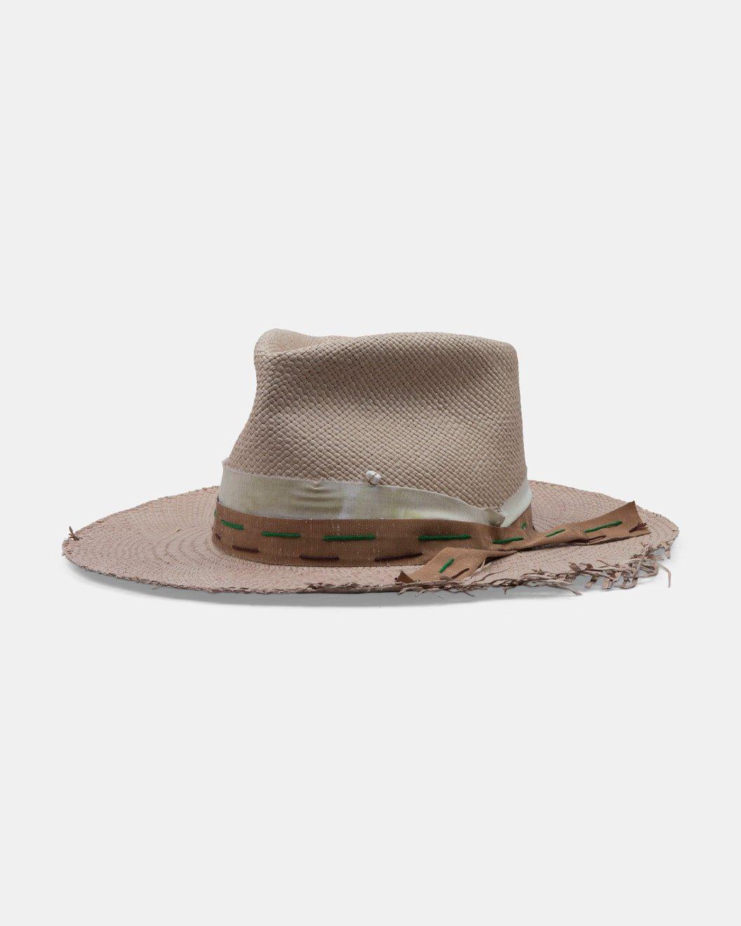 Handmade beige Panama linen hat with frayed brim and decorative ribbon on white background