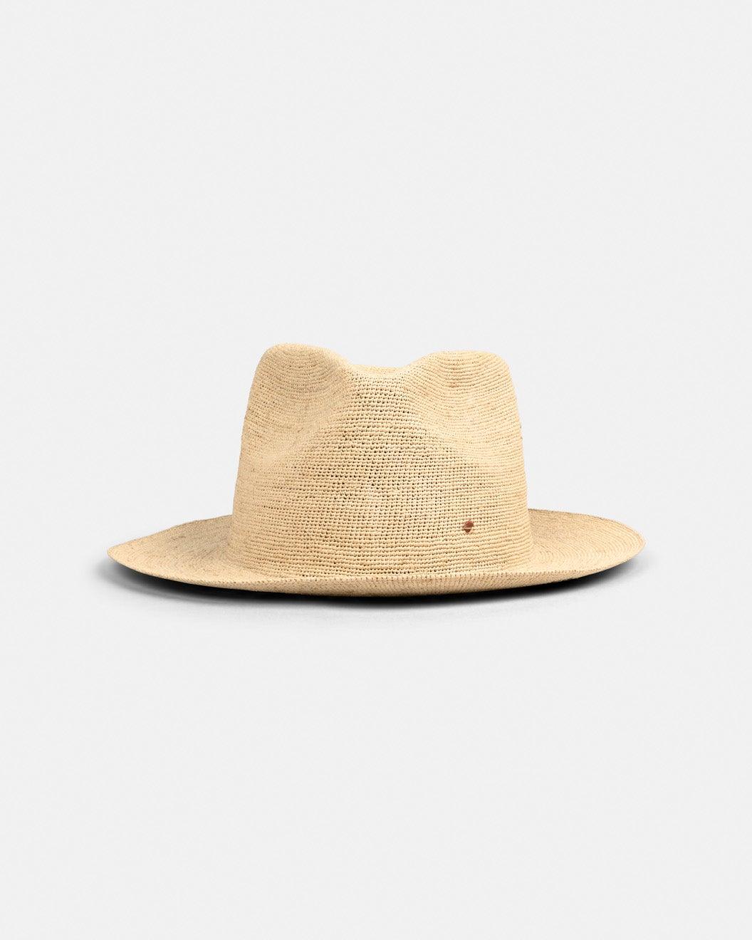 Handmade natural straw hat with wide brim and classic fedora crown on white background