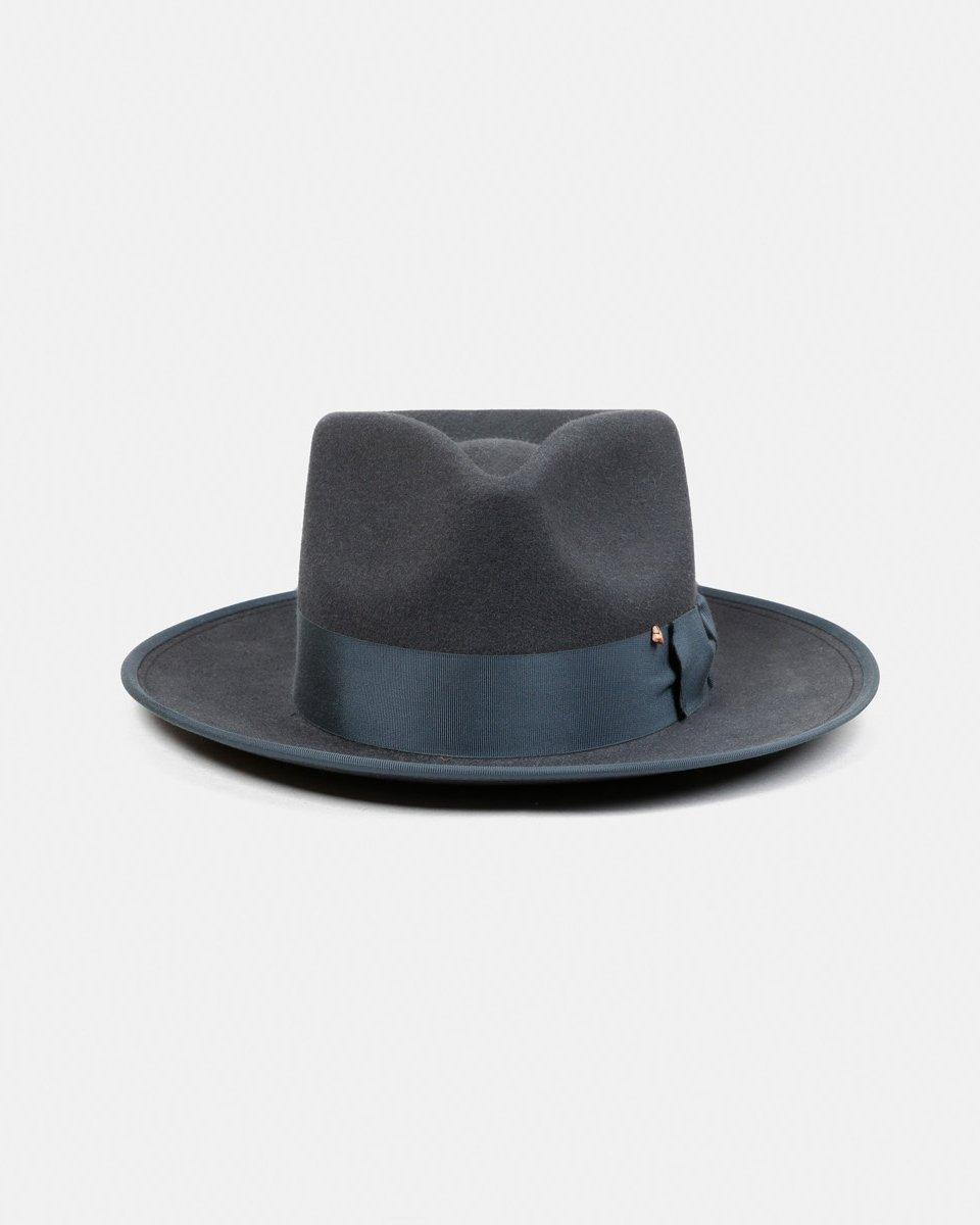 Dark blue felt fedora hat with wide brim and matching ribbon band on white background