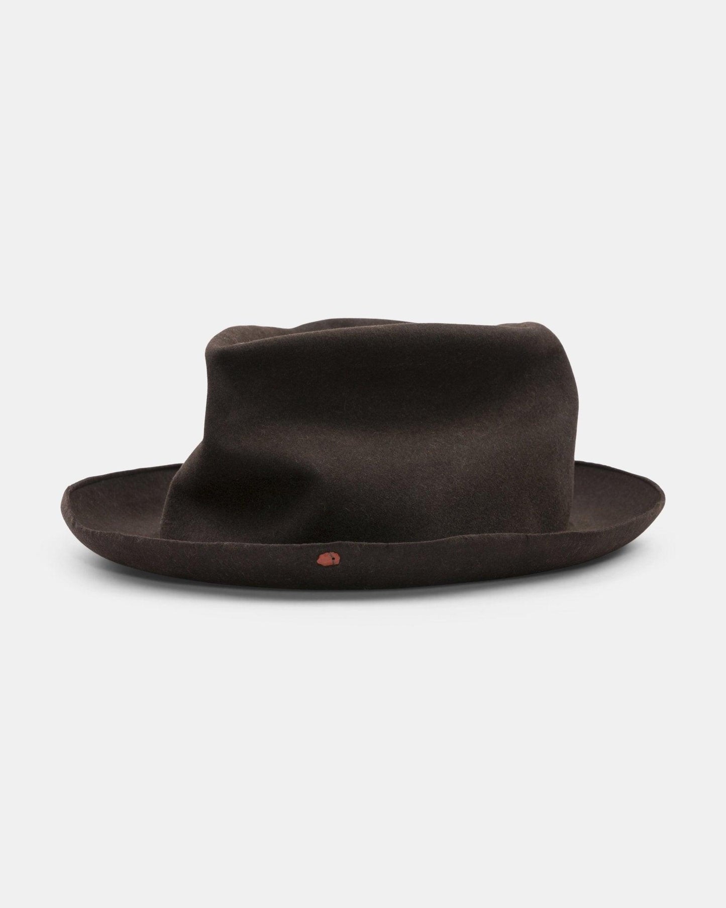 Handmade dark brown felt hat with wide brim and casual, creased crown on white background