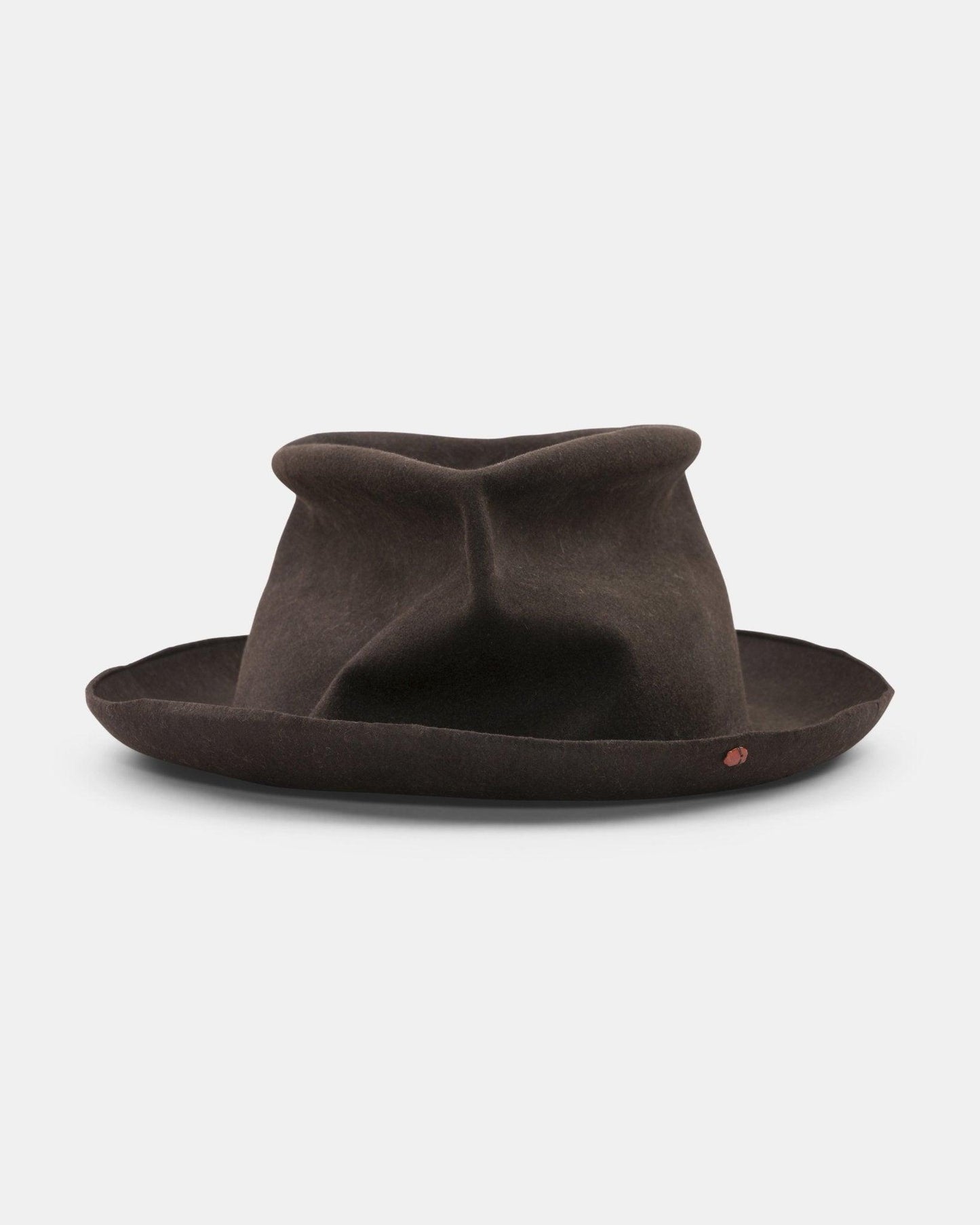 Chocolate brown felt hat with a creased crown and wide, irregular brim on white background