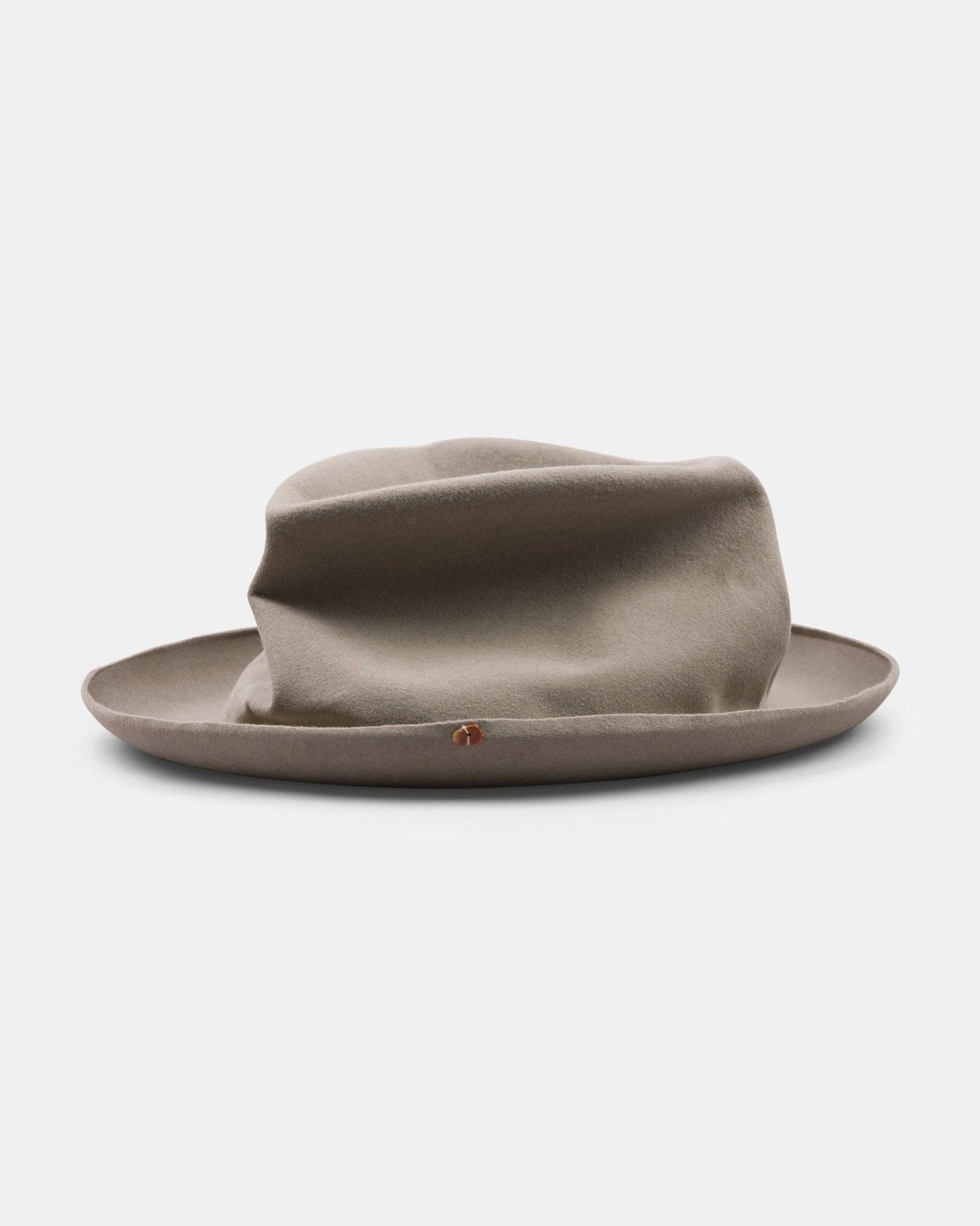 Light tan handmade Italian felt hat with a wide brim on a plain background
