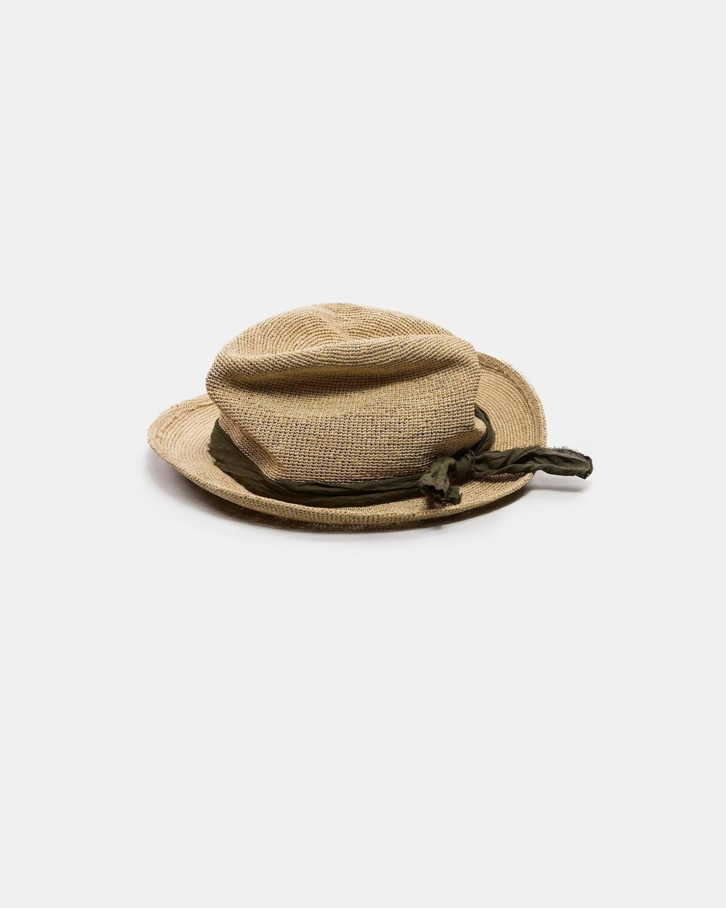 Handmade natural straw hat with wide brim and green fabric band, isolated on white